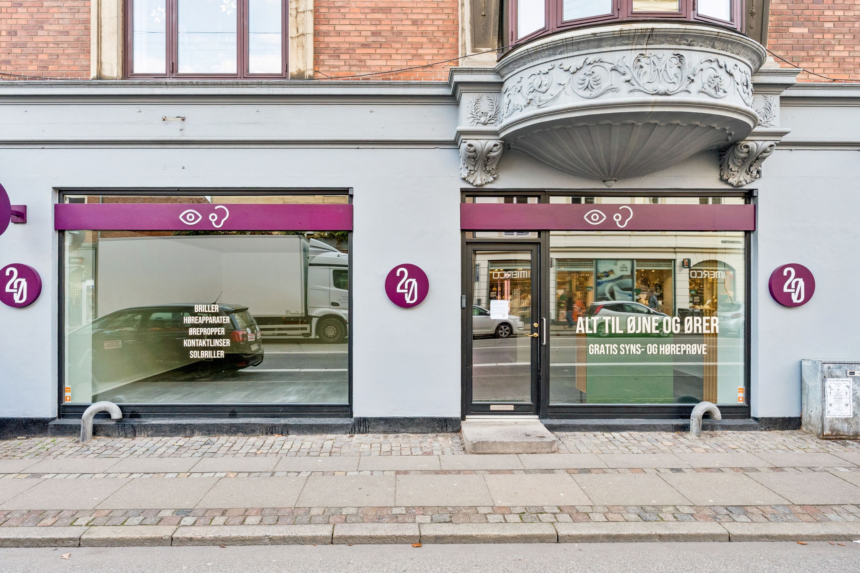 Et forretningslokal til leje på Gammel Kongevej 121, st. 1 med 162 m² og 58 m² kælder. Butikken har moderne vinduer og en stor dør med reklame for briller og brilletilbehør.