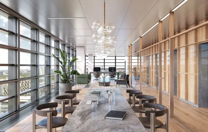 Store glasruder med udsigt over byen, moderne møbler og indretning, marmorbord med bøger og glas og en stor plante