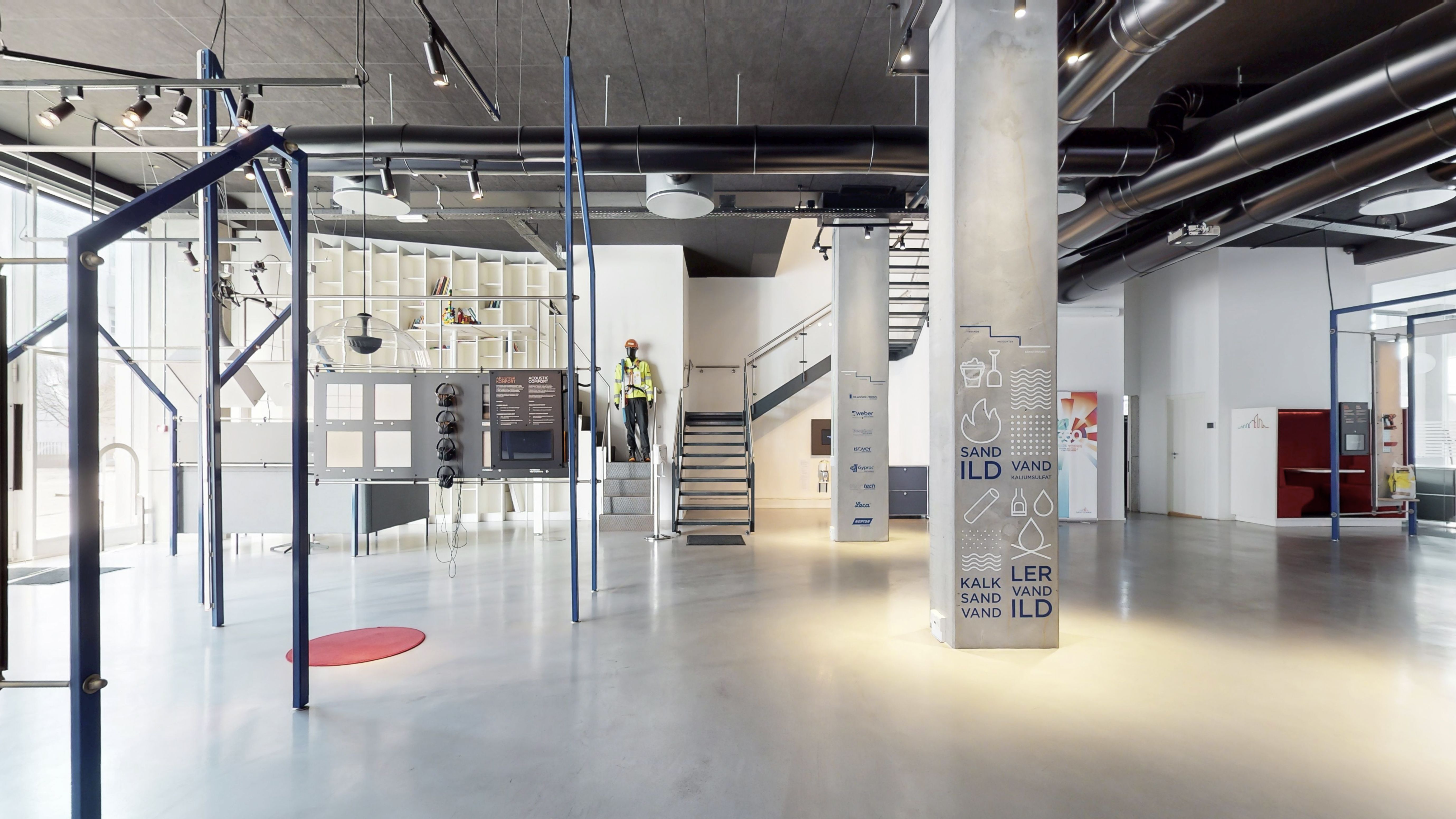 Rummeligt og funktionelt erhvervslejemål med moderne interiør og lyse vinduer. Vægmonteret infotavle og åben guldplan. To gange, ventiler og lysafmonteringer på loftet