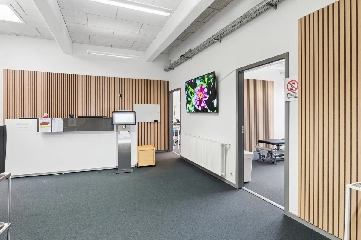 Moderne kontor med højt til loftet og en stor skærm og en simpel indretning