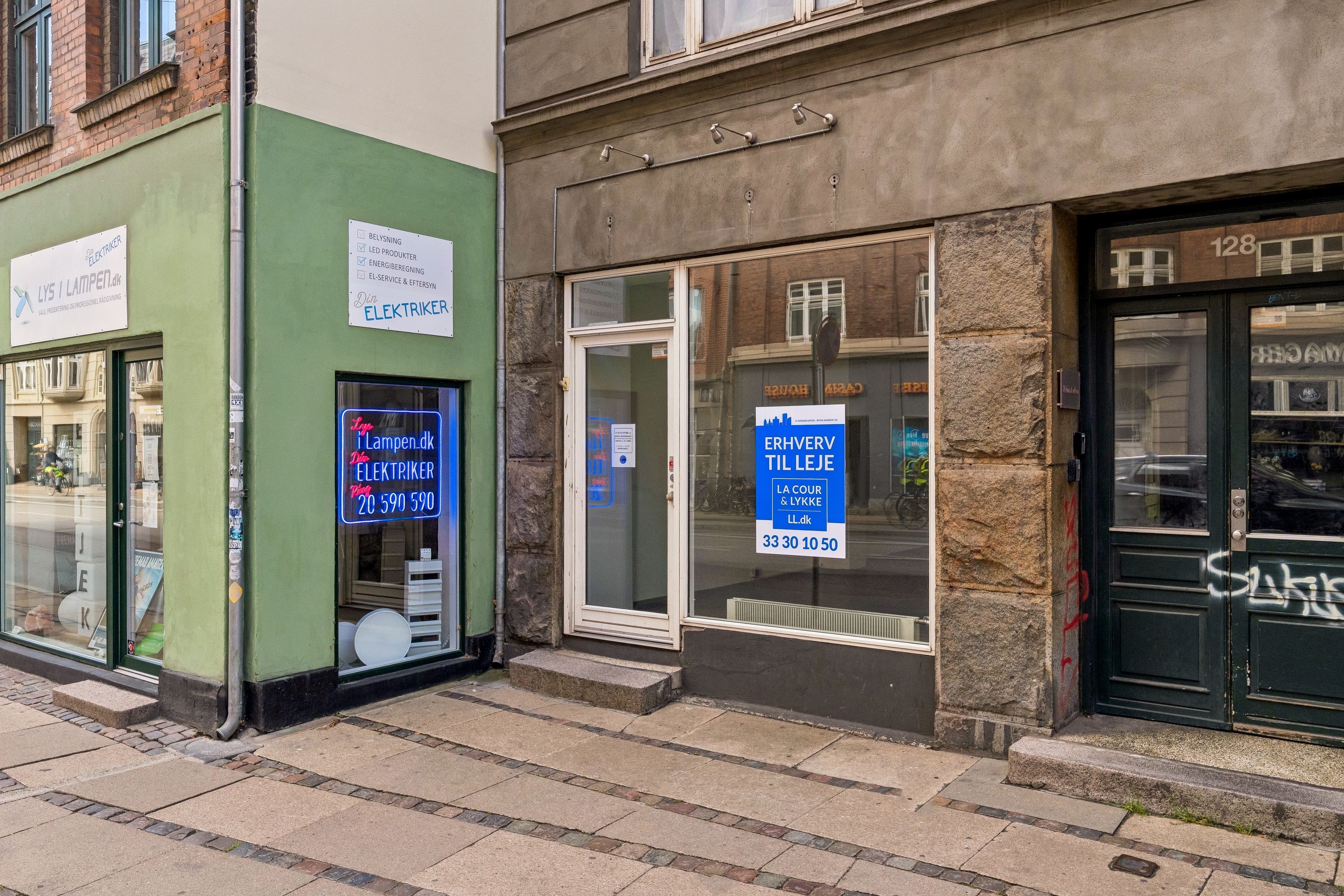 To butikker med skrifterne lys i lampen og elektriker i neon. De nævner henholdsvis lyset og lampen samt elektrikerne og årsagerne til at kontakte dem.