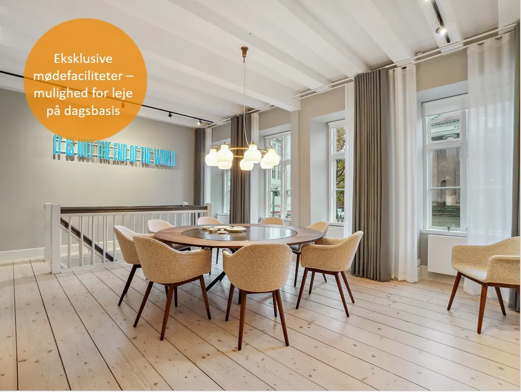 På billedet er der et lyse og pænt nyt køkken med moderne møbler og lyse lofter