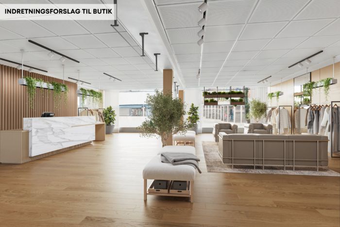 Butikslokale med stort vinduesparti, lyse lofter, højt gulv og moderne møbler og planteelementer i sammensætning med en