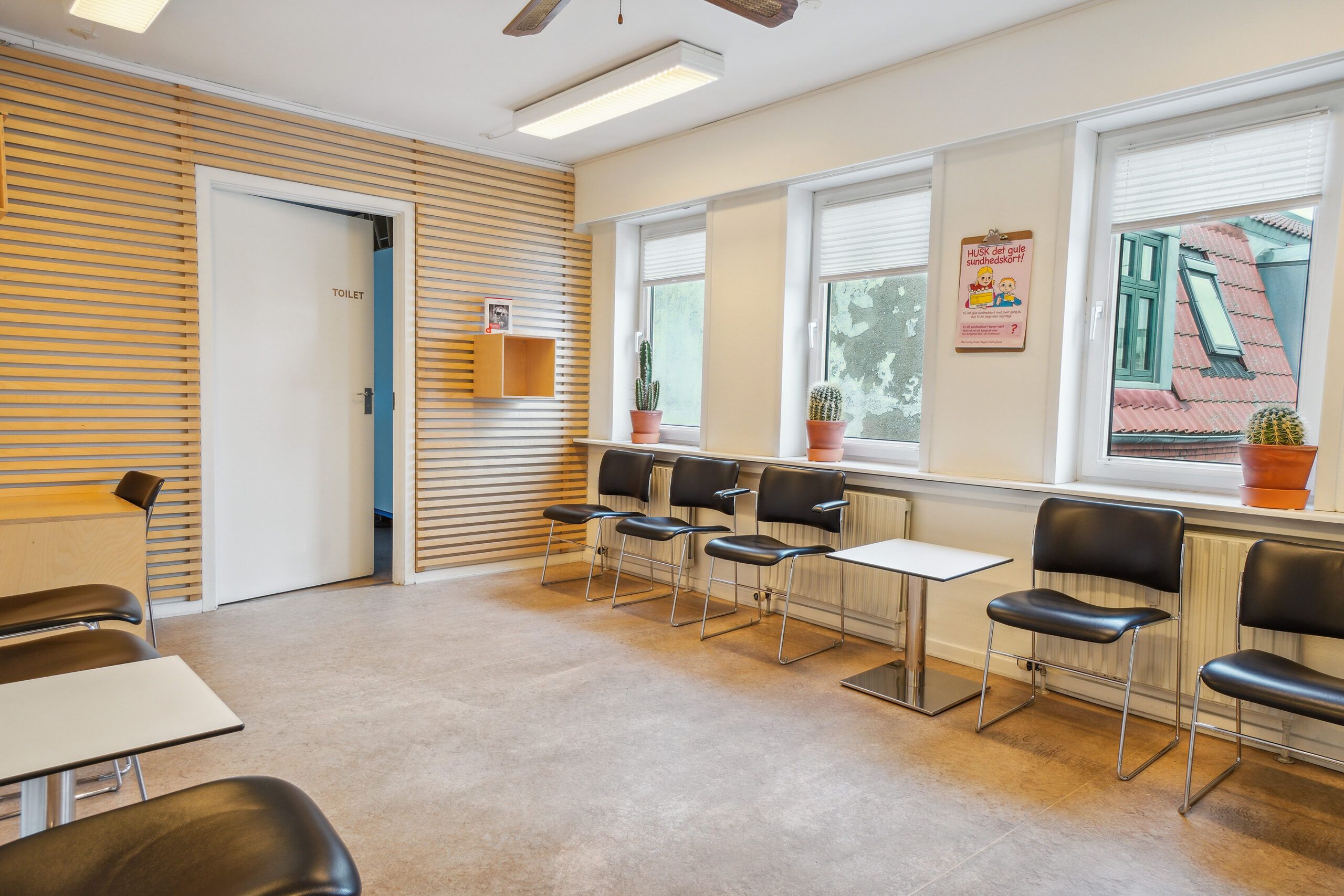 Et moderne venteværelse med lyse og rene vægge og gulv samt moderne møbler og indretning.