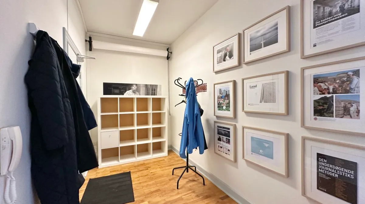 Lejlighed med hængehylde, garderobe, hængeklæder og flere billeder på væggen