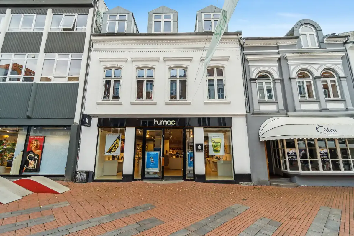 Rummelige butikslokaler med glasvinduer og hvide facader i en smuk bygning i Helligkorsgade 12 i København