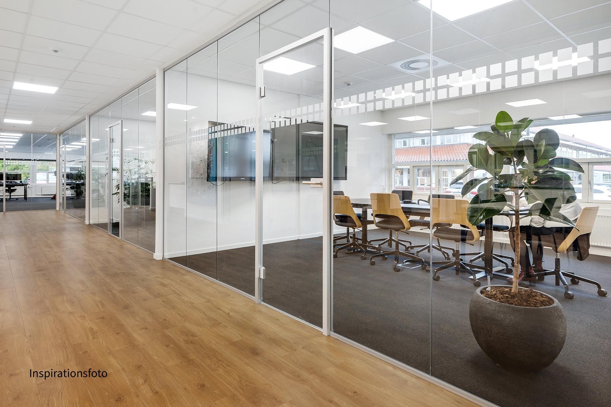 Store møde- og konferencelokaler med høje glasvægge og lyse lofter. Glasserum med moderne møbler og store plantepot.