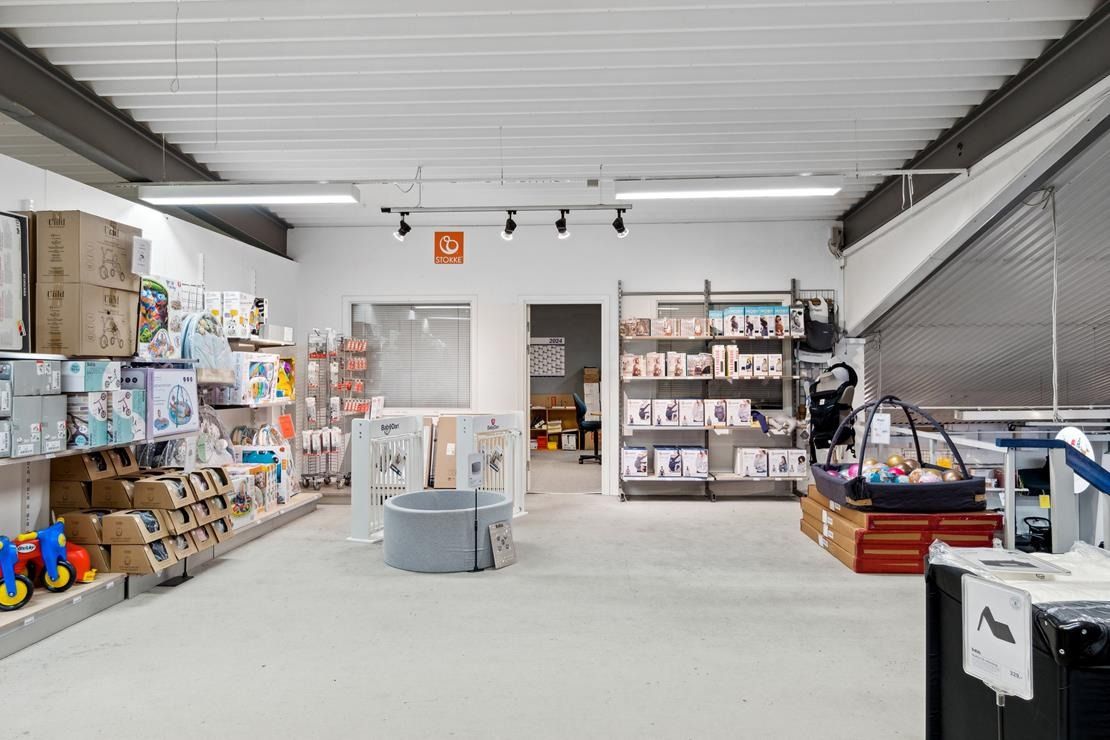 En butik med diverse babyprodukter og møbler, der er placeret på en stor og ren butiksgulv med flere hylder og produkter til