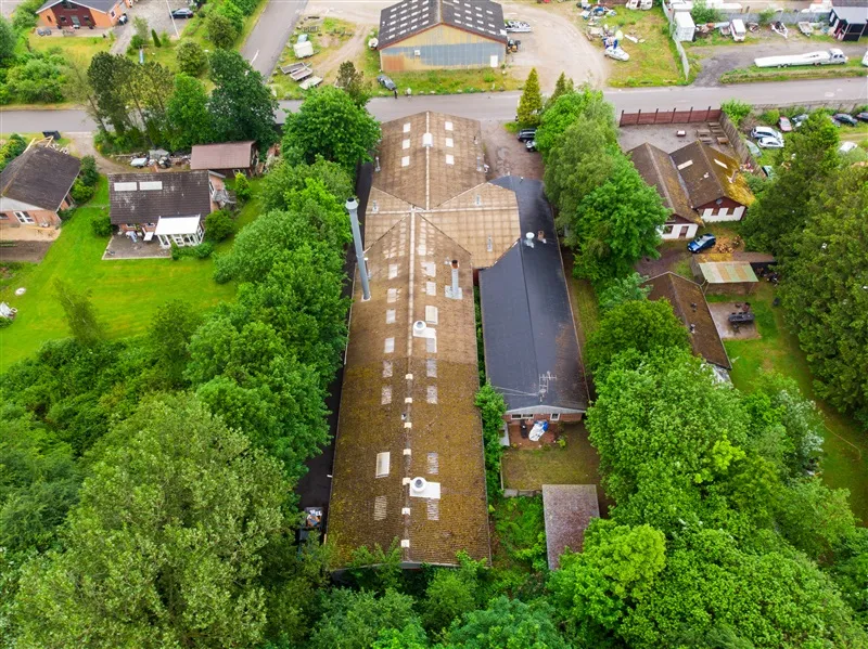 Foto af et erhvervsområde med flere bygninger, udstyret med tagbegroelse og vinduer