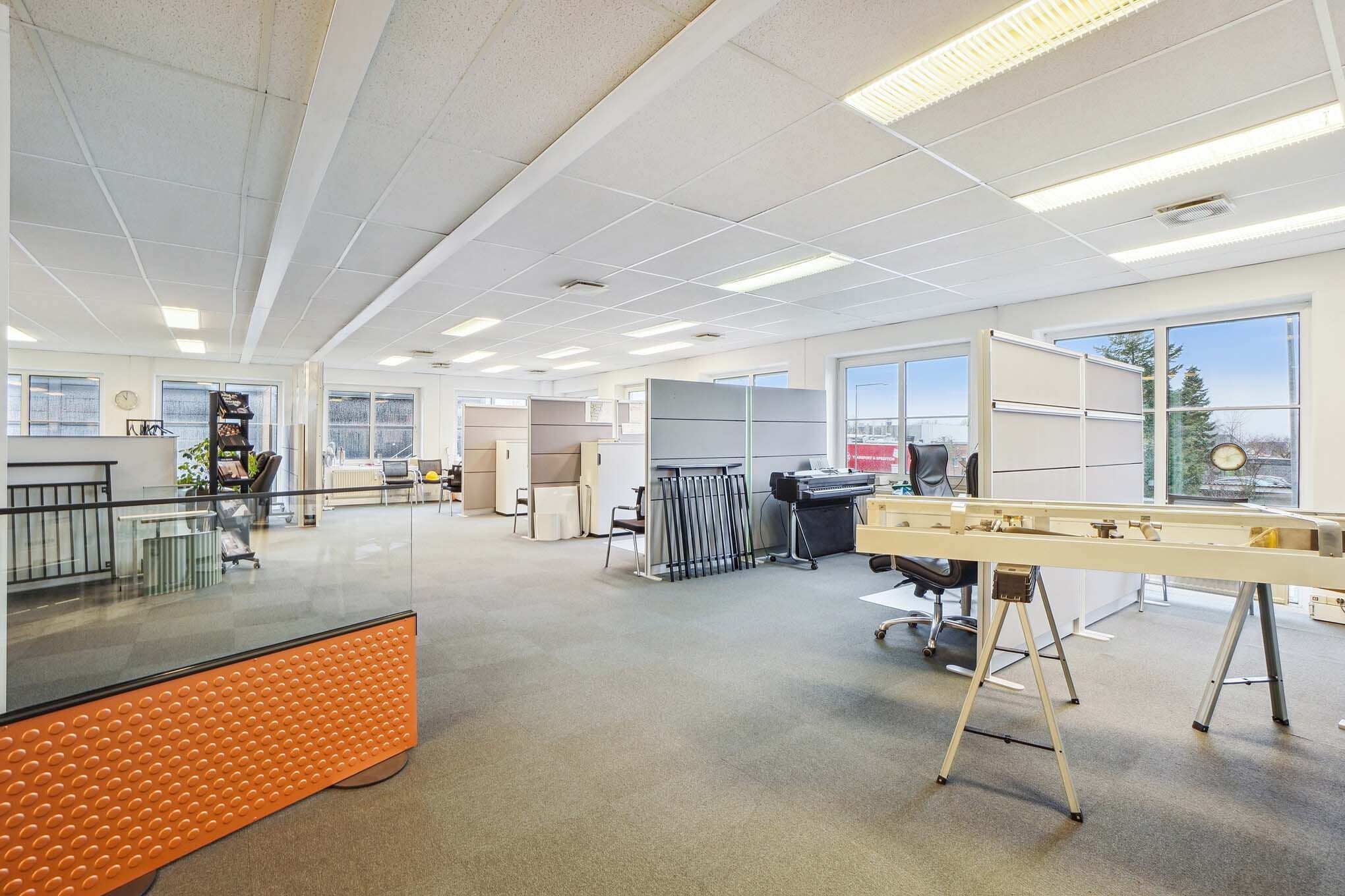 Det er en moderne og veludstyret arbejdsplads med lyse lofter og store vinduer for meget naturlys