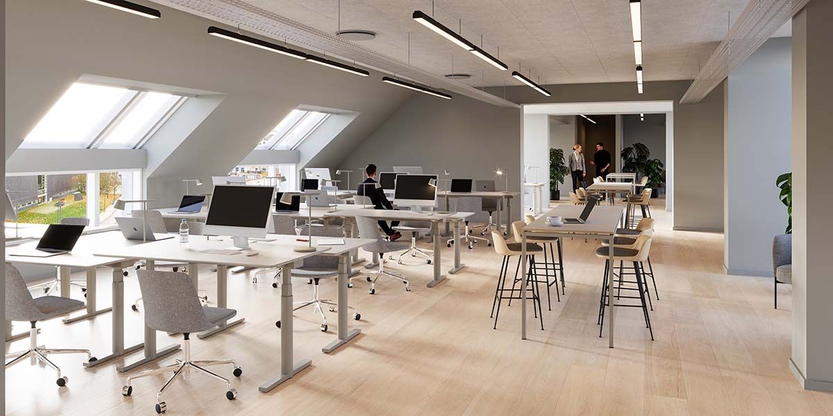 Moderne kontor med højloft, lyse loftsvindue, skriveborde og stole, computere og mødested, medarbejdere i baggrunden, lyse,