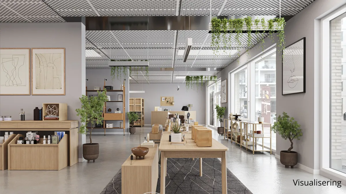 Her ses et moderne interiør med lyse vægge og træmøbler, og der er plante i potter samt to store billeder på væggen