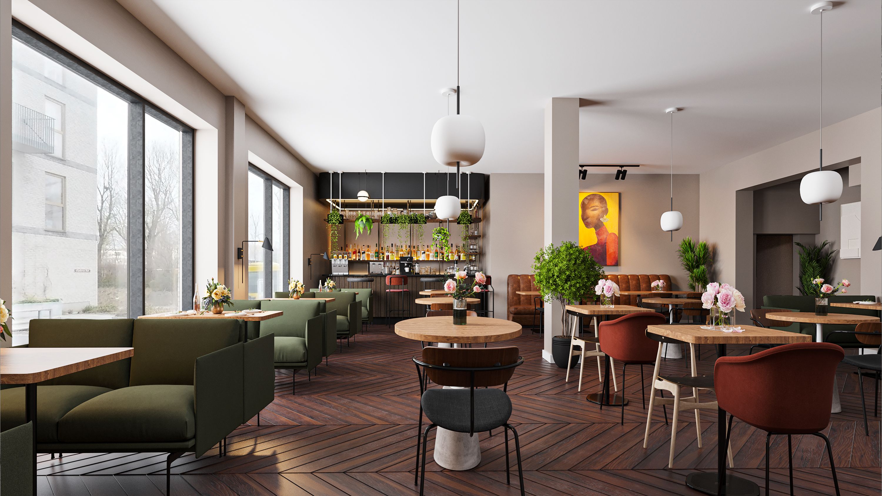 En ny restaurant med grønne møbler, røde stole, plante-dekorationer, lysekroner og et kunstværk på væggen