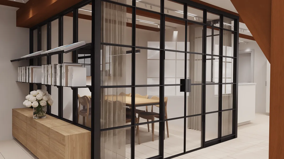 Indvendigt billede af et moderne kontor med sort glasvæg, hvid gulv og lyse møbler