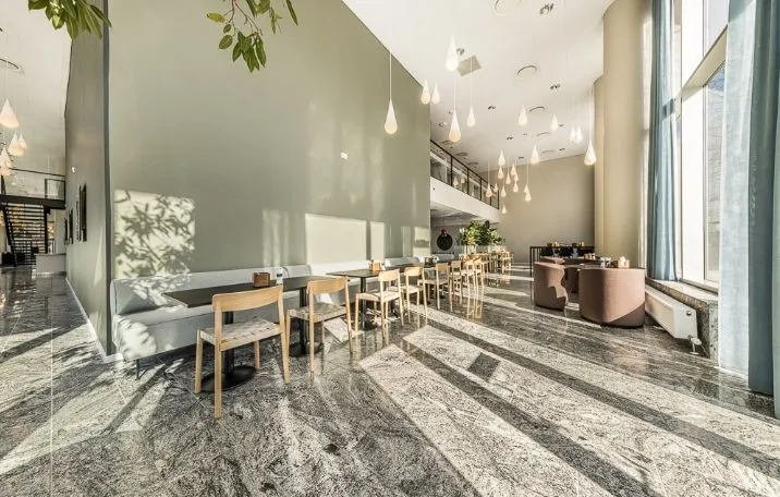 Moderne kontor med elegant møblering og marmorgulve, udendørs terrasse og udsigt til Amager Fælled