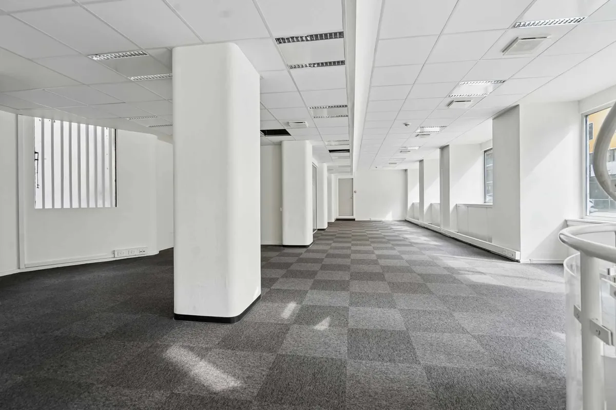 Smuk, velholdt rødstensejendom med hvide vægge, højt loft og krydsformede gulvbelægninger på Nørrebrogade.