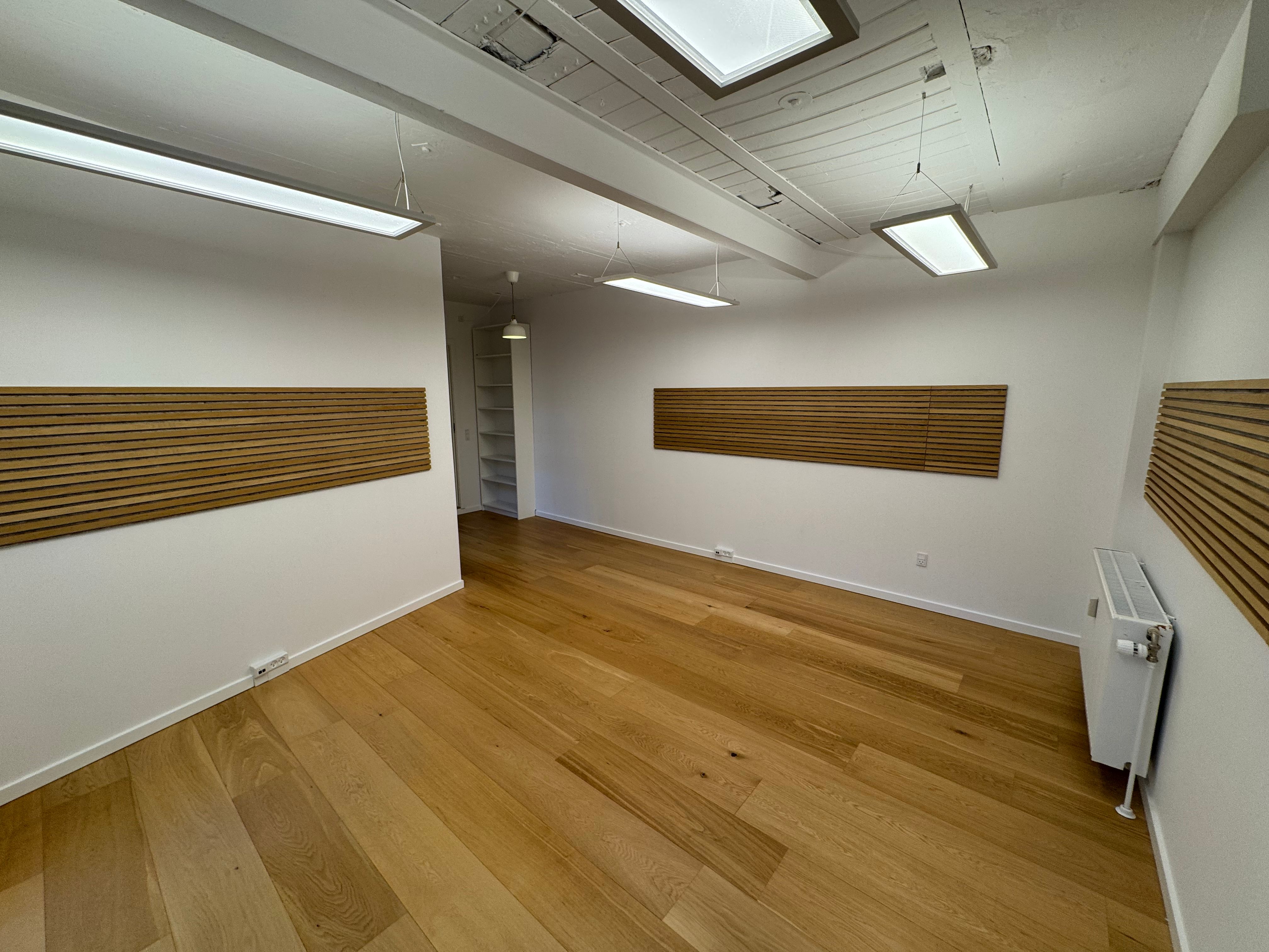 Ledig kontorlokaler med højt til loftet og masser af lys. Store vinduer og åbent gulvplan med hårdt trægulv. To lyse