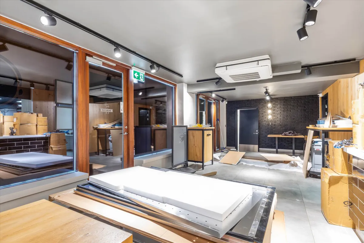 Investeringsejendom med møbler og elektronik, der er pakket i kasser og liggende på gulvet. Her er en spisestue og et køkken