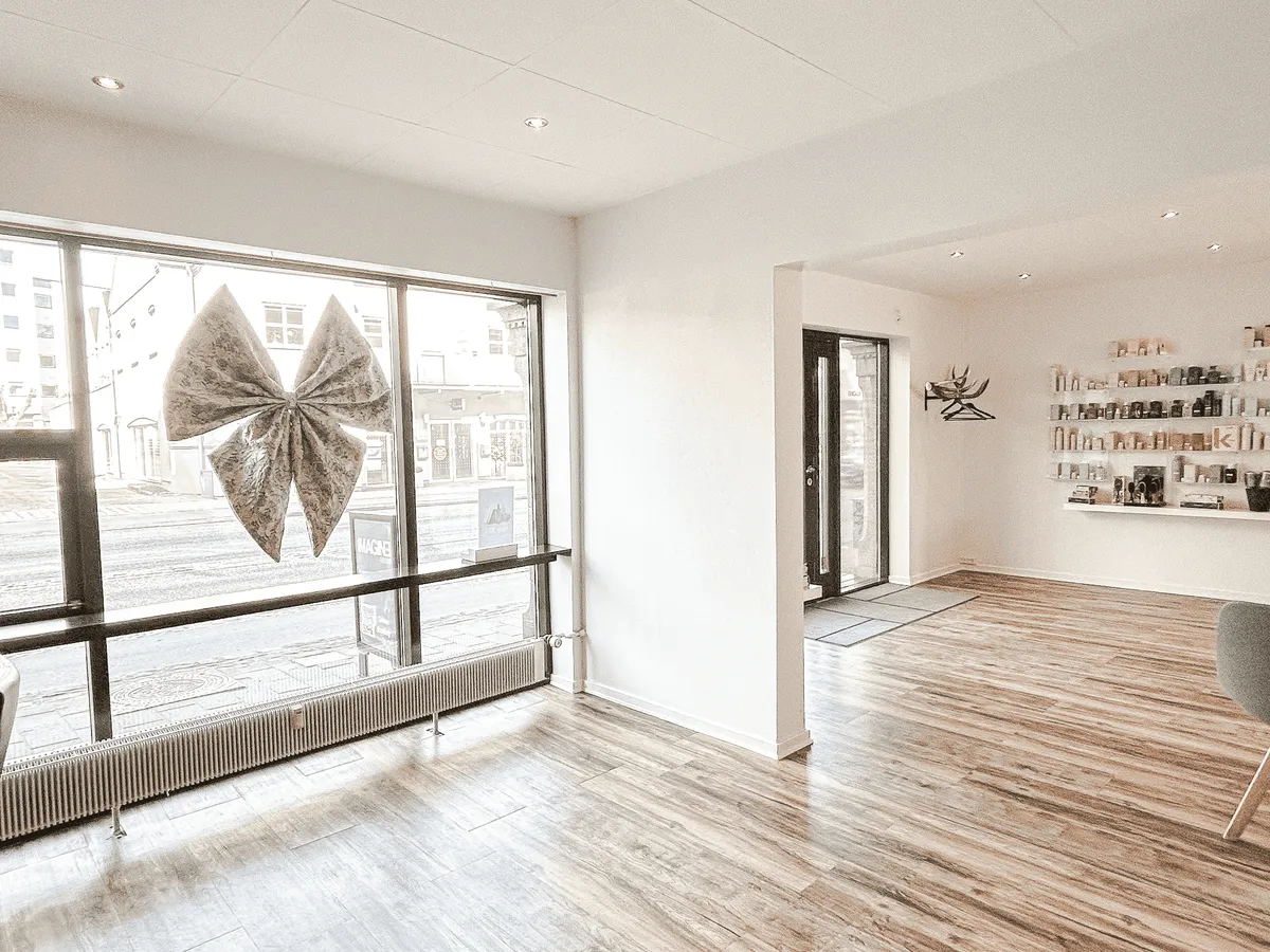 En velholdt og veludstyret interiør med højloftede rum, lyse hvide vægge og et elegant designelement i form af et stort