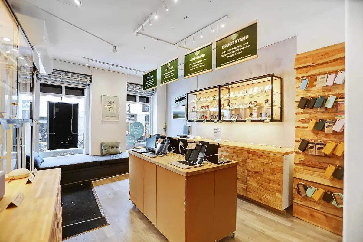Kontor med flere bærbare computere til rådighed, eksponeret produkt i kabinetter og kvalitetsmaterialer i interiøret.