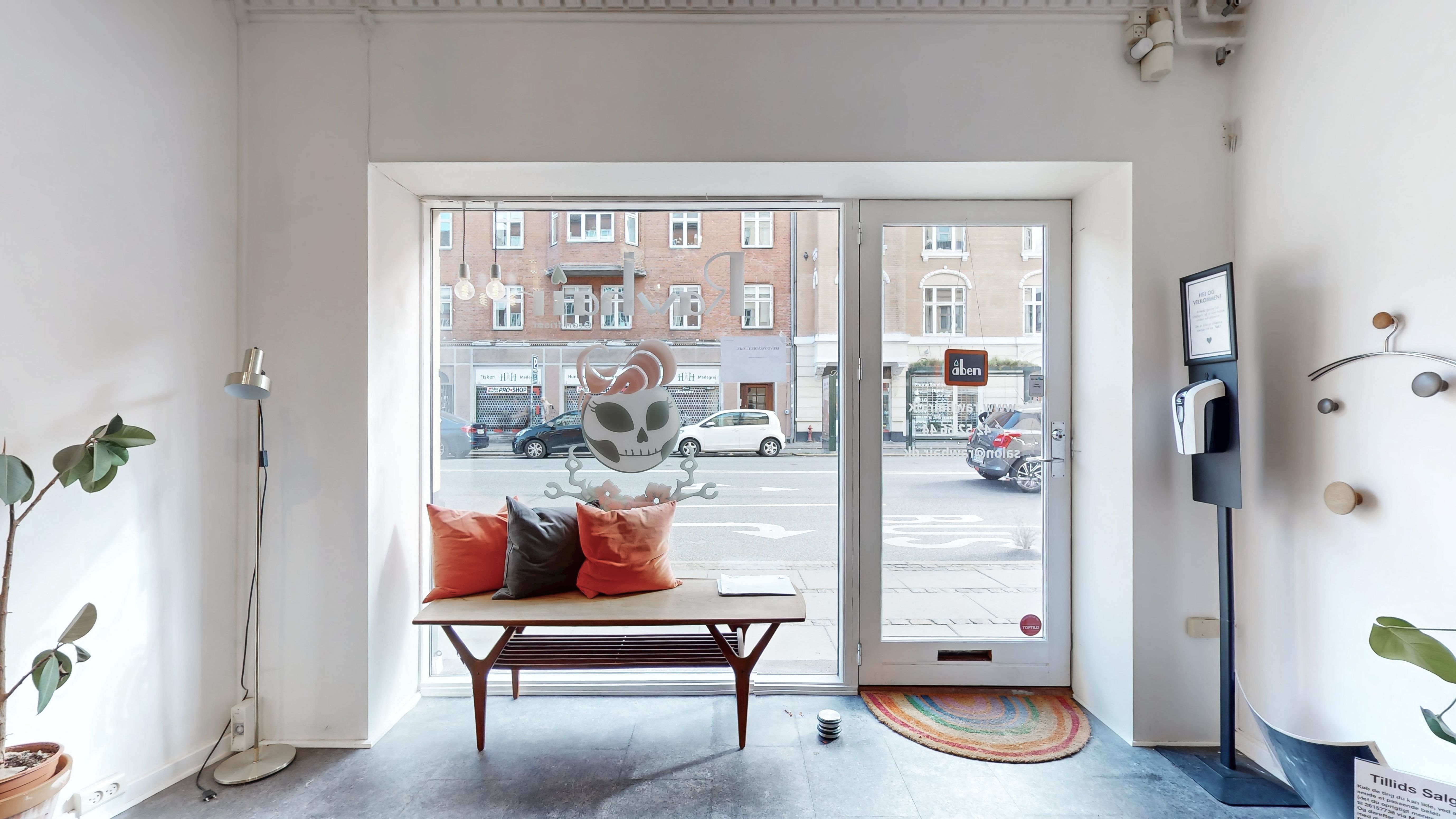 Indvendigt smukke lokaler med møbler og dekorationer samt vinduer med udsigt til gaden og kørende biler